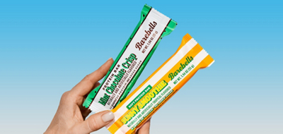 Woman holding two Barebells bars