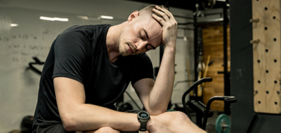 A man sitting down looking tired