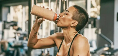 A woman drinking from a water bottle